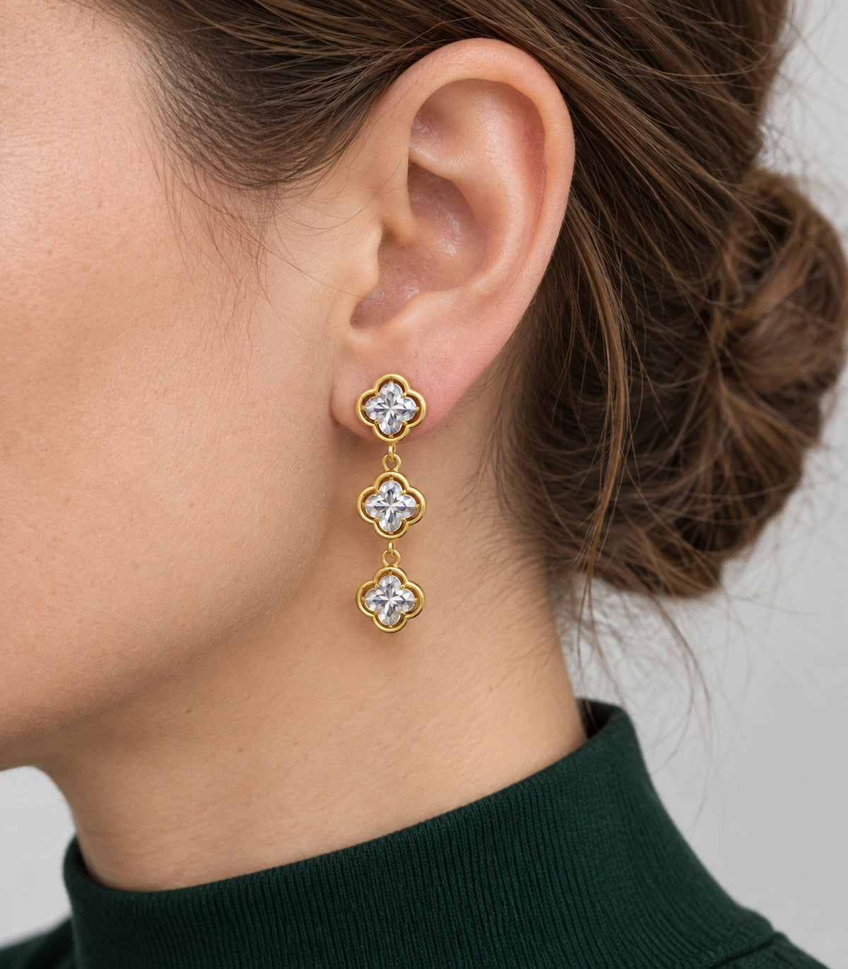JIMIKI Triple Quatrefoil Crystal Drop Earring Pair in Gold tone / clear, model wearing view #color_gold tone / clear