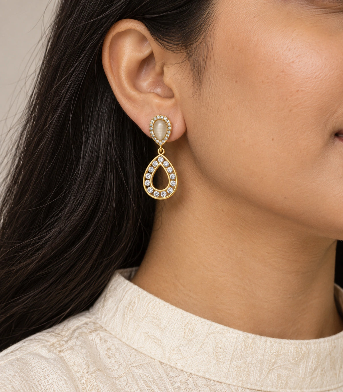 JIMIKI Gold Tone Cream Teardrop Crystal Halo Drop Earring Pair in Gold tone / Cream, model wearing view
