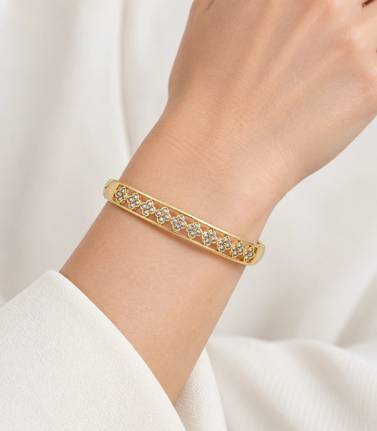JIMIKI Gold-Tone Crystal Floral Lattice Bangle — worn on the wrist #color_gold-tone / clear