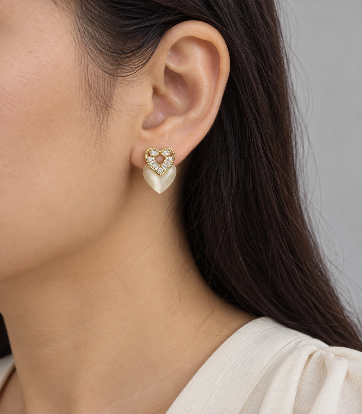 JIMIKI Gold-Tone Crystal Heart Stud Earring Pair in Gold Tone, model wearing view