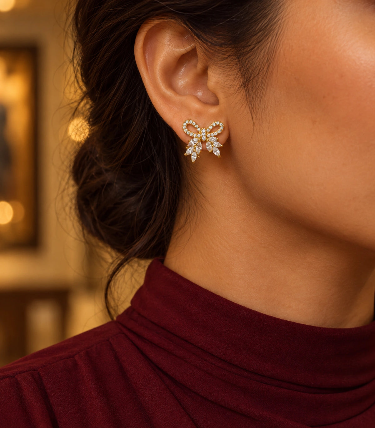JIMIKI Gold-Tone Crystal Loop Bow Stud Earrings in Gold / Clear, editorial model view