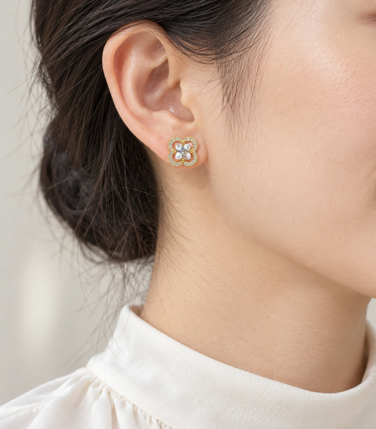 JIMIKI Crystal Quatrefoil Halo Stud Earring Pair in Gold Tone, model wearing view #color_gold tone