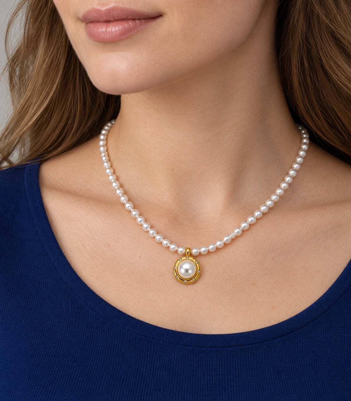 JIMIKI Gold Tone Crystal Rim Pearl Pendant Necklace in Gold / White, editorial model view