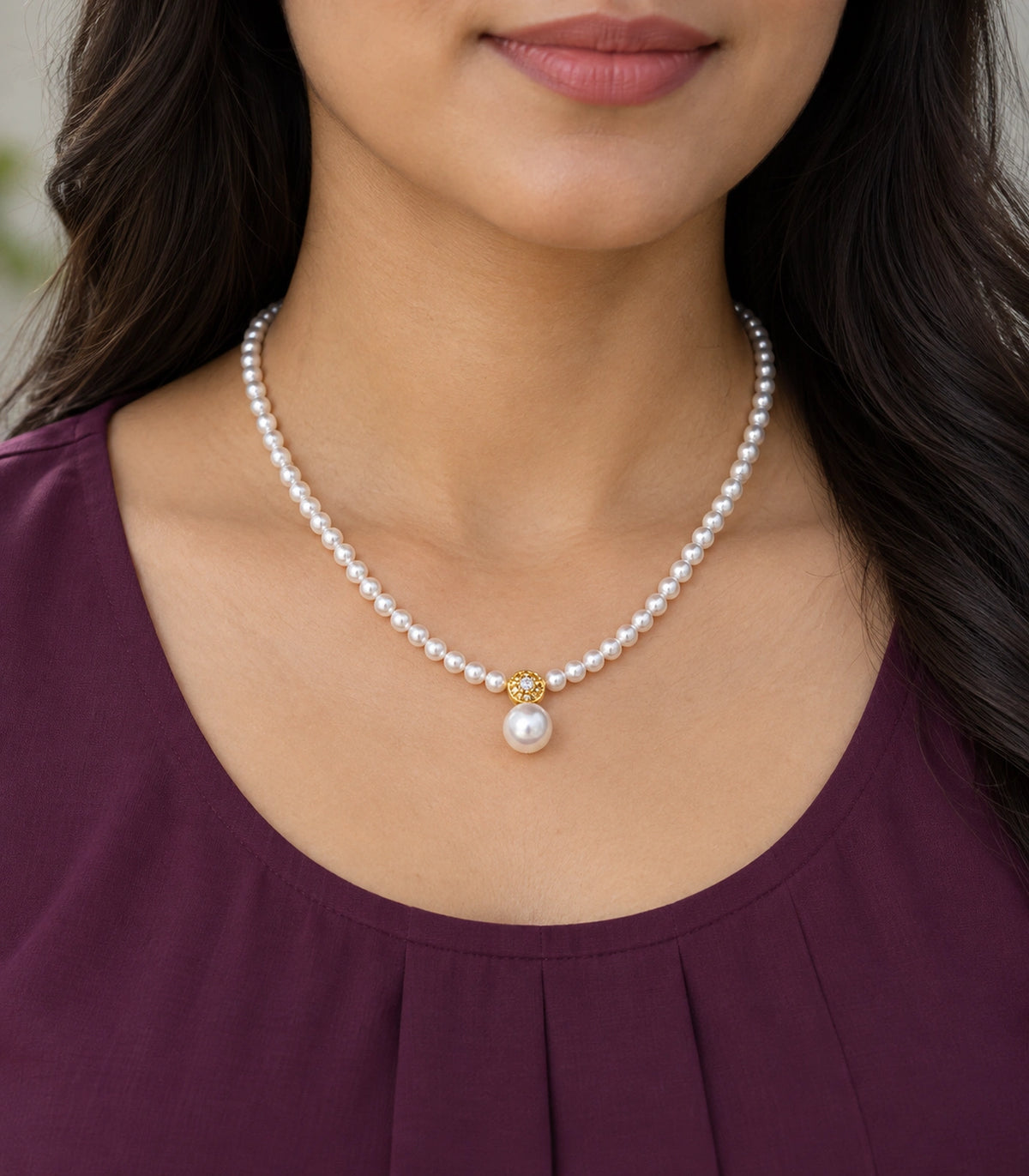 JIMIKI Gold Tone Crystal Rosette Pearl Drop Necklace in Gold / White, model wearing view