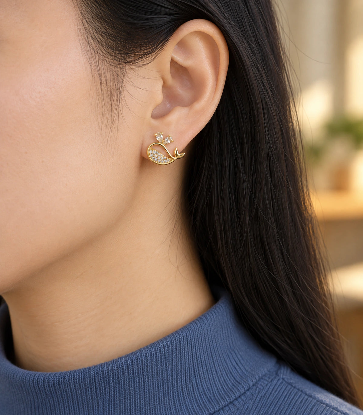 JIMIKI Crystal Whale Stud Earring Pair in Gold-tone, editorial model view #color_gold-tone