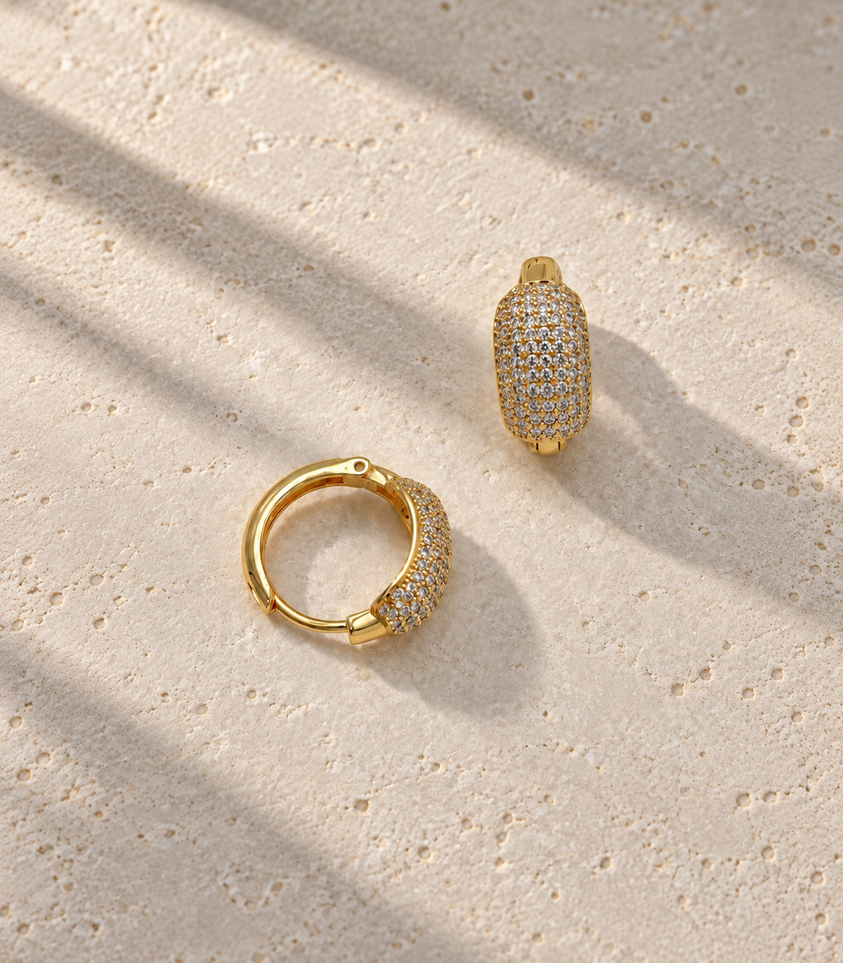JIMIKI gold-tone domed pave hinged hoop earring pair — editorial flat lay