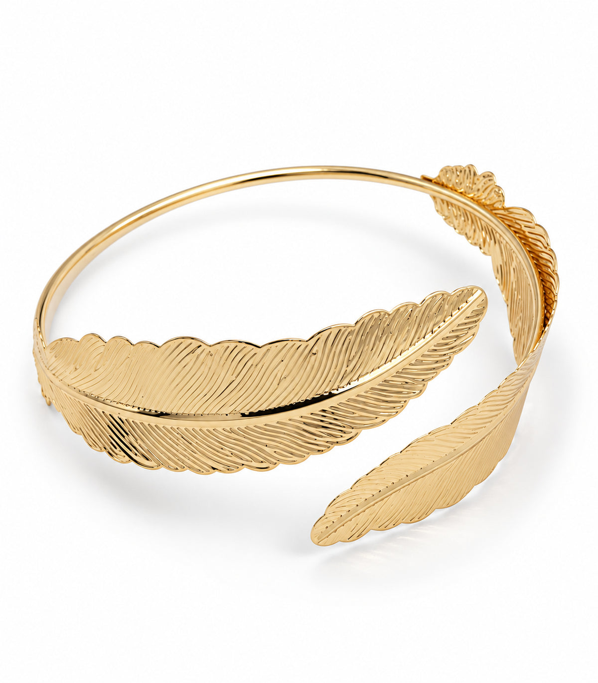 Gold-tone open arm cuff with two engraved feather terminals on white background