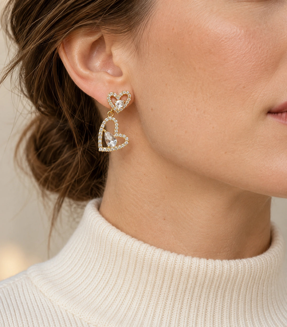 JIMIKI Double Heart Pear Crystal Drop Earrings in Gold Tone, editorial model view #color_gold tone