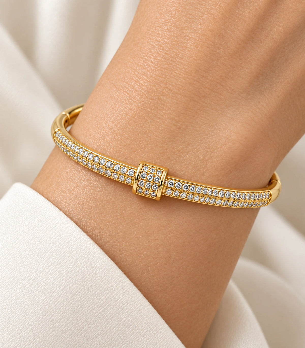 JIMIKI Gold-Tone Double Row Pavé Buckle Bangle — close-up of the bangle worn on the wrist #color_gold-tone / clear