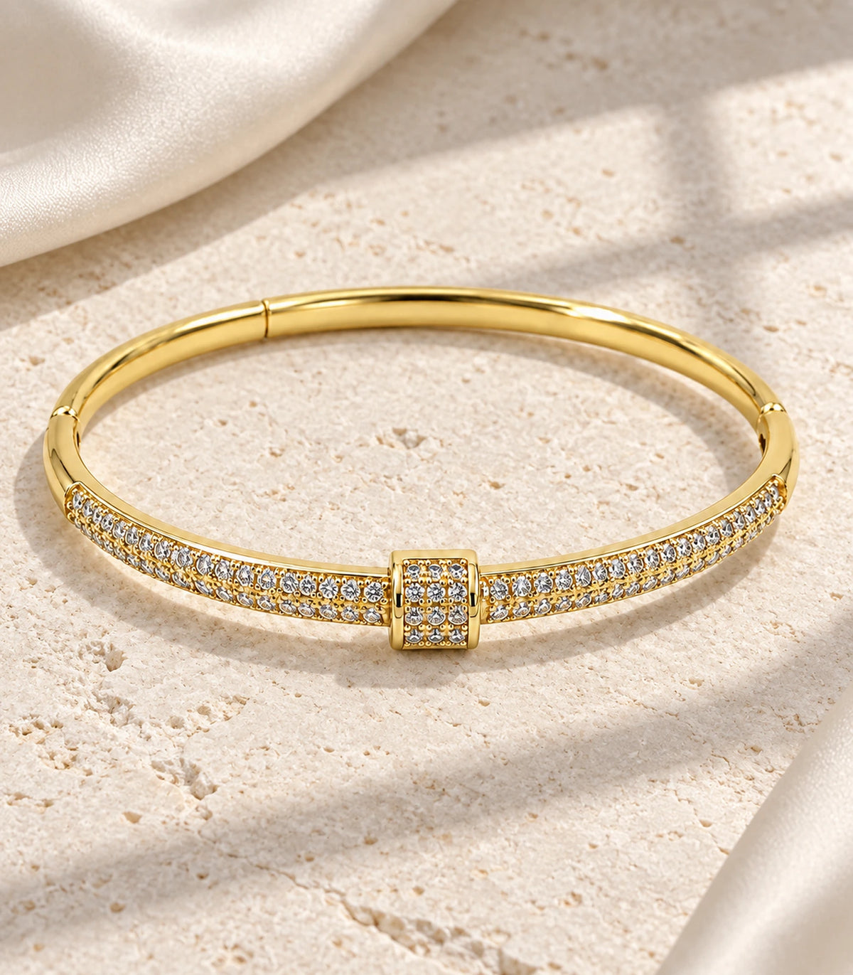 JIMIKI Gold-Tone Double Row Pavé Buckle Bangle — bangle in a styled flat lay #color_gold-tone / clear