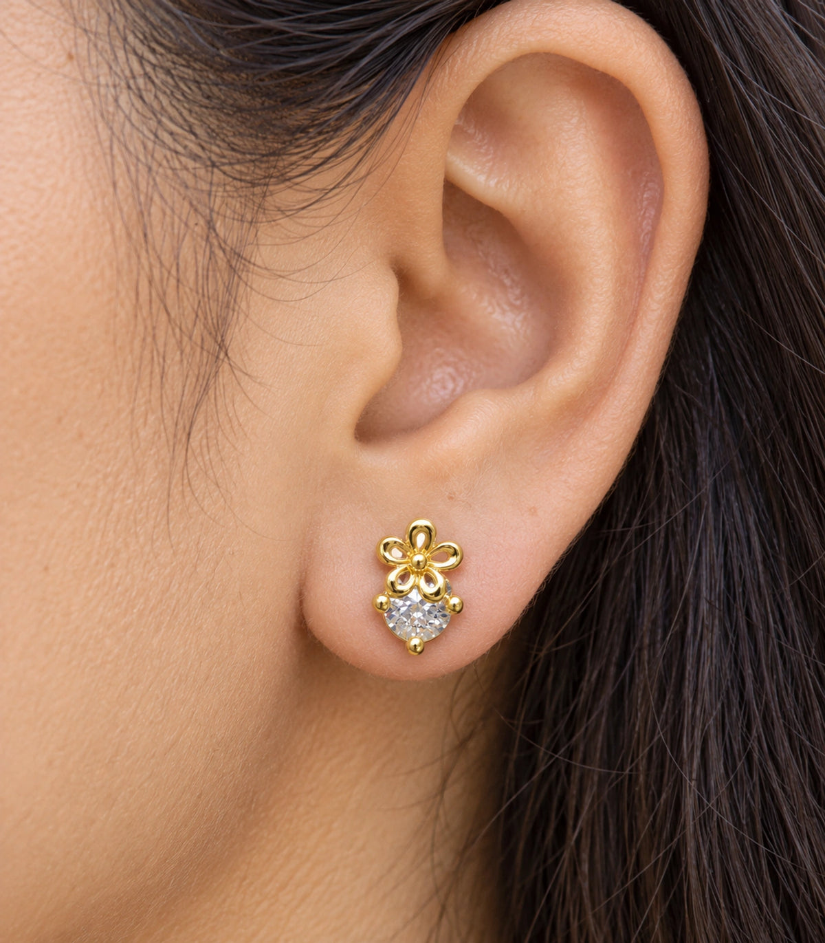 JIMIKI Gold Tone Flower Solitaire Stud Earrings — worn close-up detail #color_gold-tone