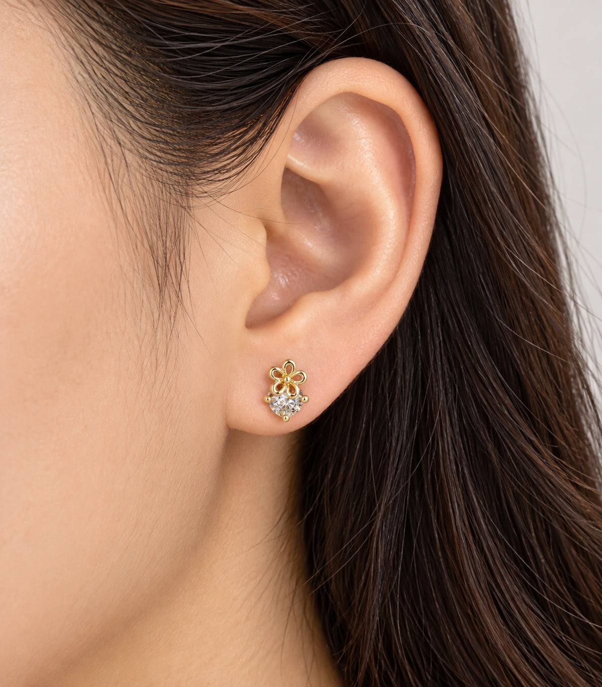 JIMIKI Gold Tone Flower Solitaire Stud Earrings — worn styling view #color_gold-tone