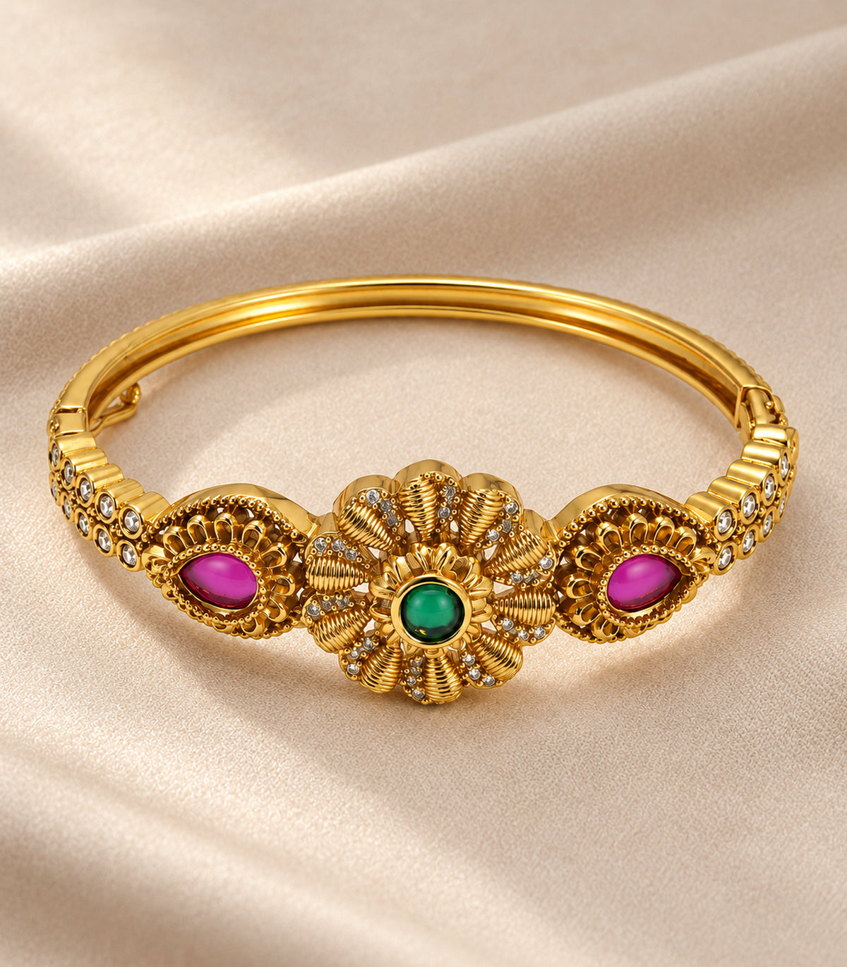 Gold-tone green flower and magenta teardrop single bangle — editorial flatlay view