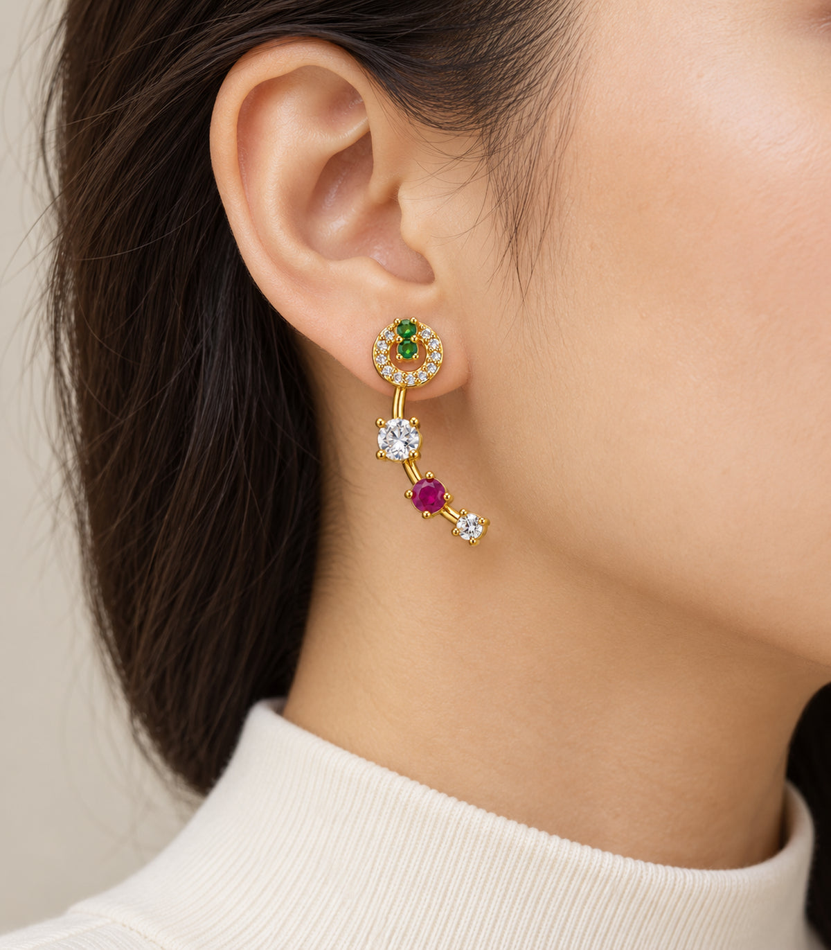 Gold-tone green and magenta curved crystal earrings - closeup view