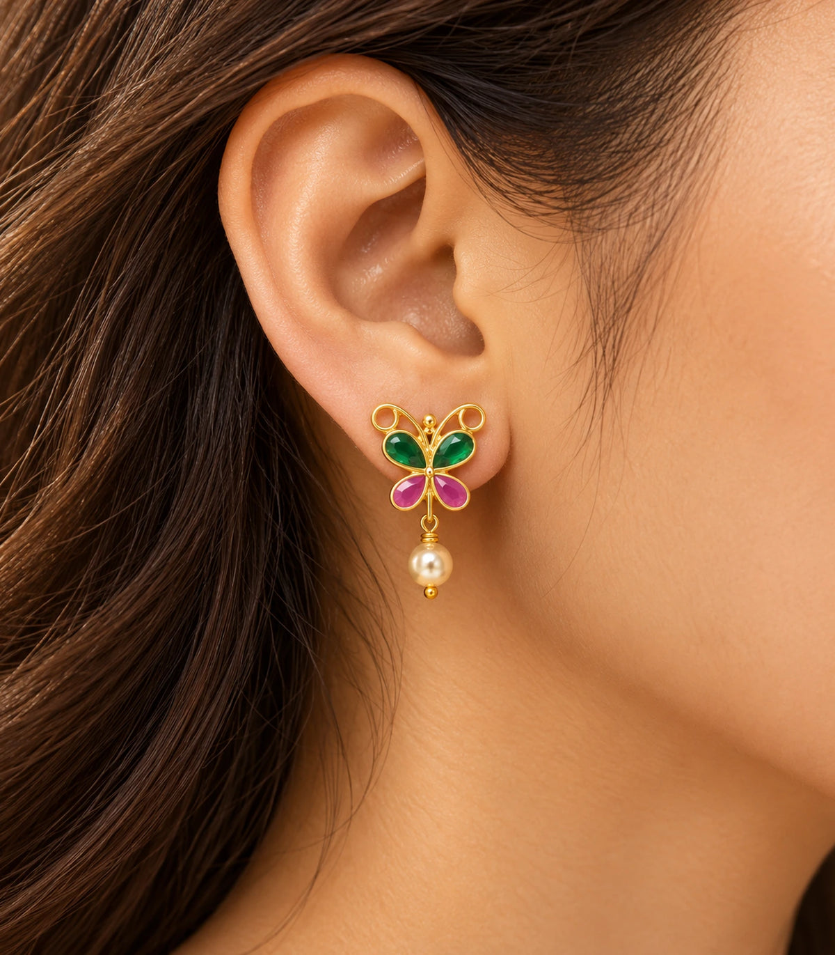 JIMIKI Green & Pink butterfly pearl drop earrings, worn in warm editorial lighting #color_green-pink