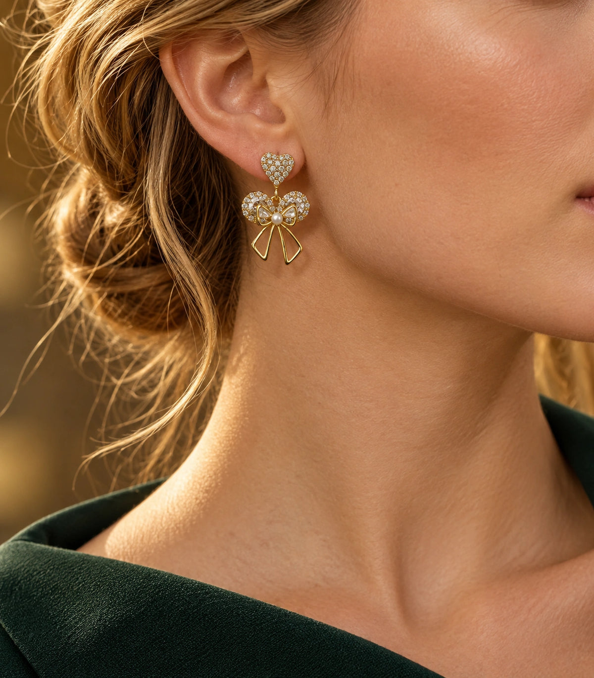 JIMIKI Gold-Tone Heart Bow Pearl Drop Earrings in Gold / Clear / White, editorial model view