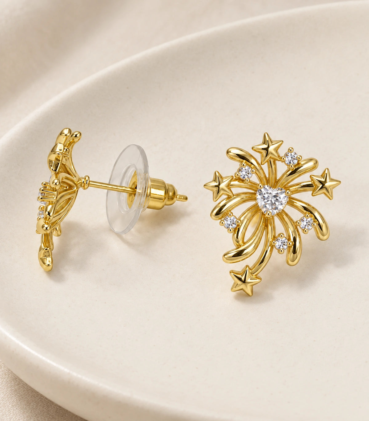 JIMIKI Heart Crystal Starburst Stud Earring Pair in Gold tone/Clear, editorial flat lay #color_gold tone/clear