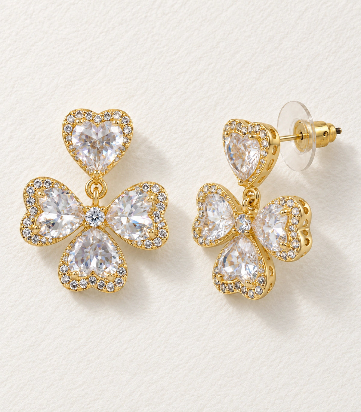 JIMIKI Heart Crystal Three Petal Drop Earring Pair in Gold-tone, editorial flat lay #color_gold-tone