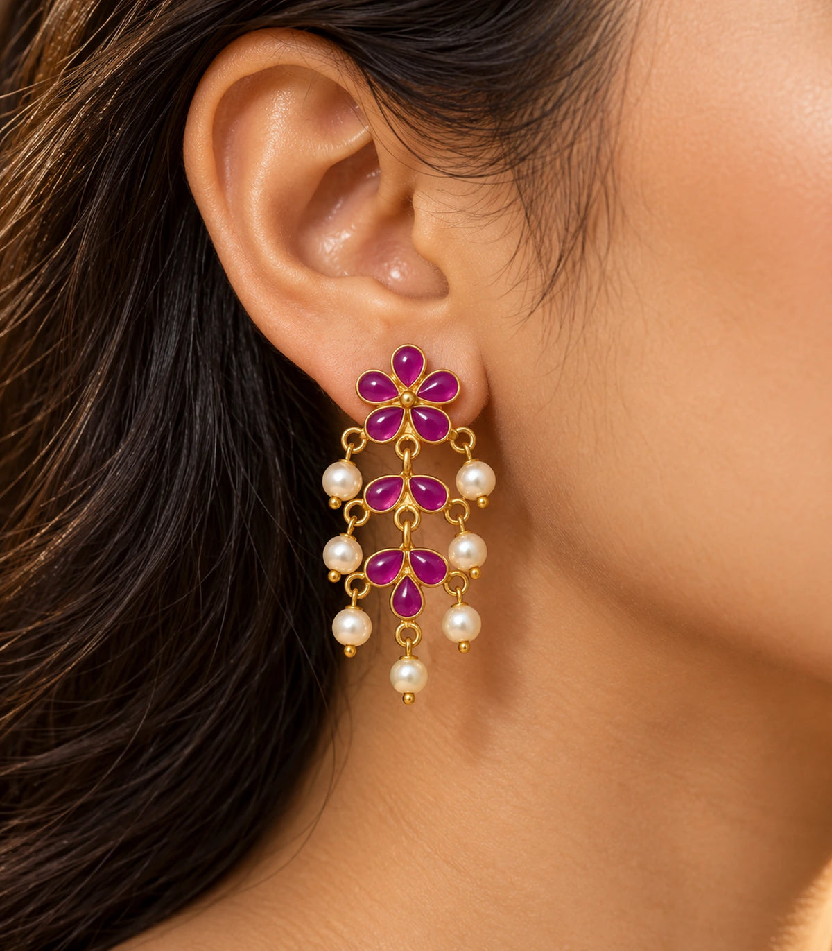 JIMIKI magenta floral pearl-style chandelier earrings, worn in warm editorial light #color_magenta