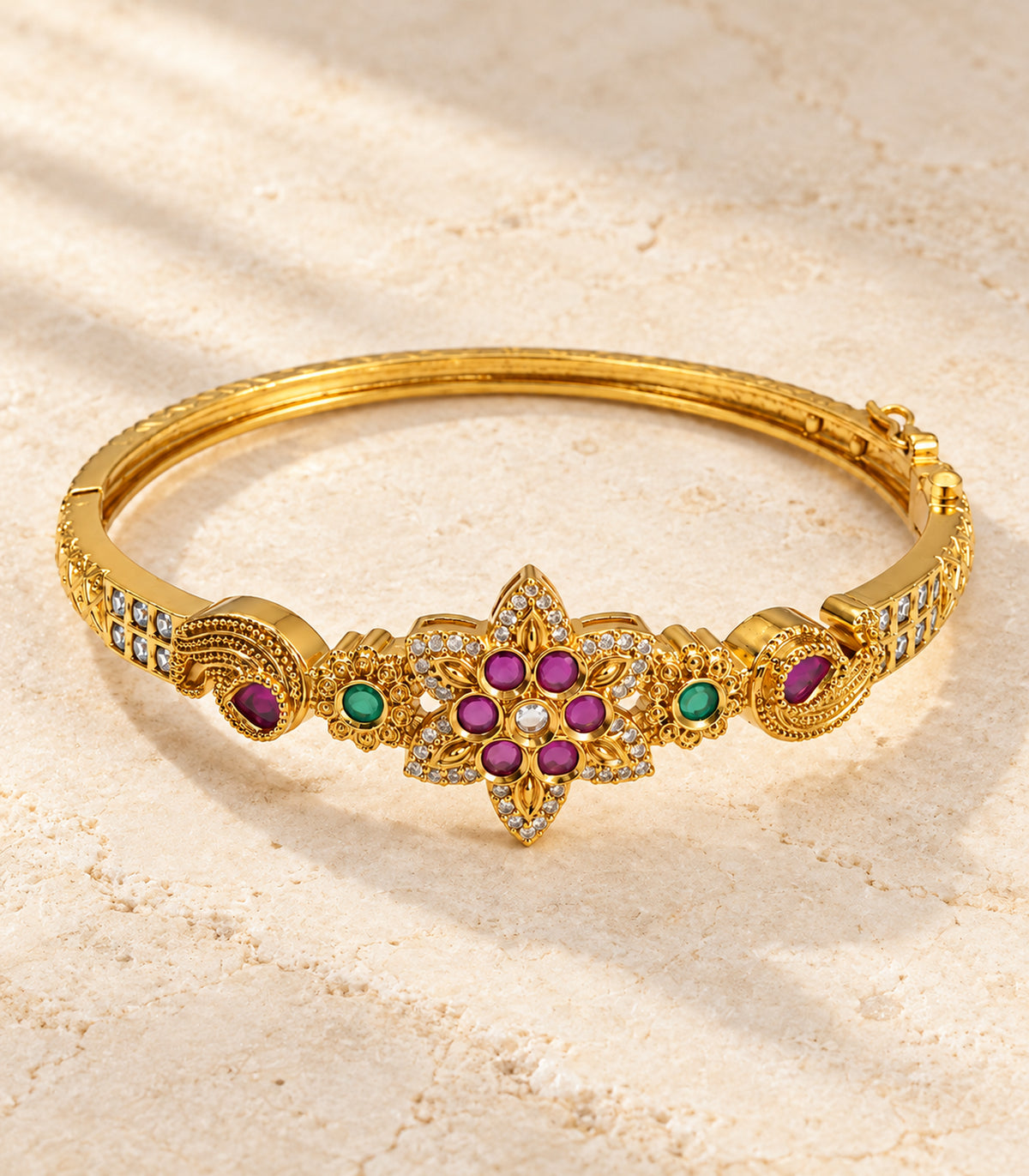 Gold-tone magenta six-stone floral bangle — editorial-flatlay view; single bangle