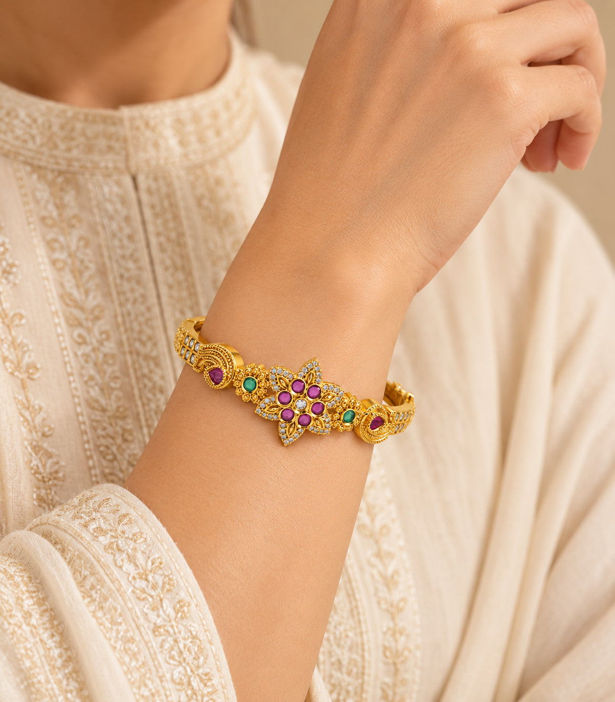 Gold-tone magenta six-stone floral bangle — editorial-model view; single bangle