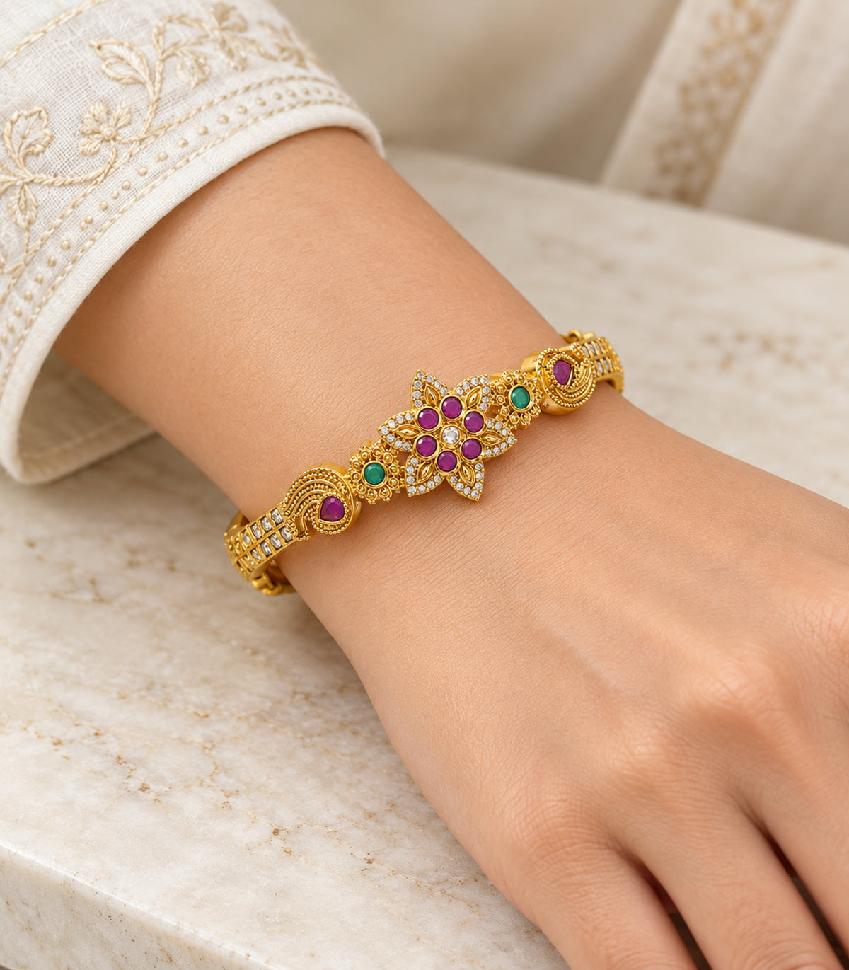 Gold-tone magenta six-stone floral bangle — model view; single bangle