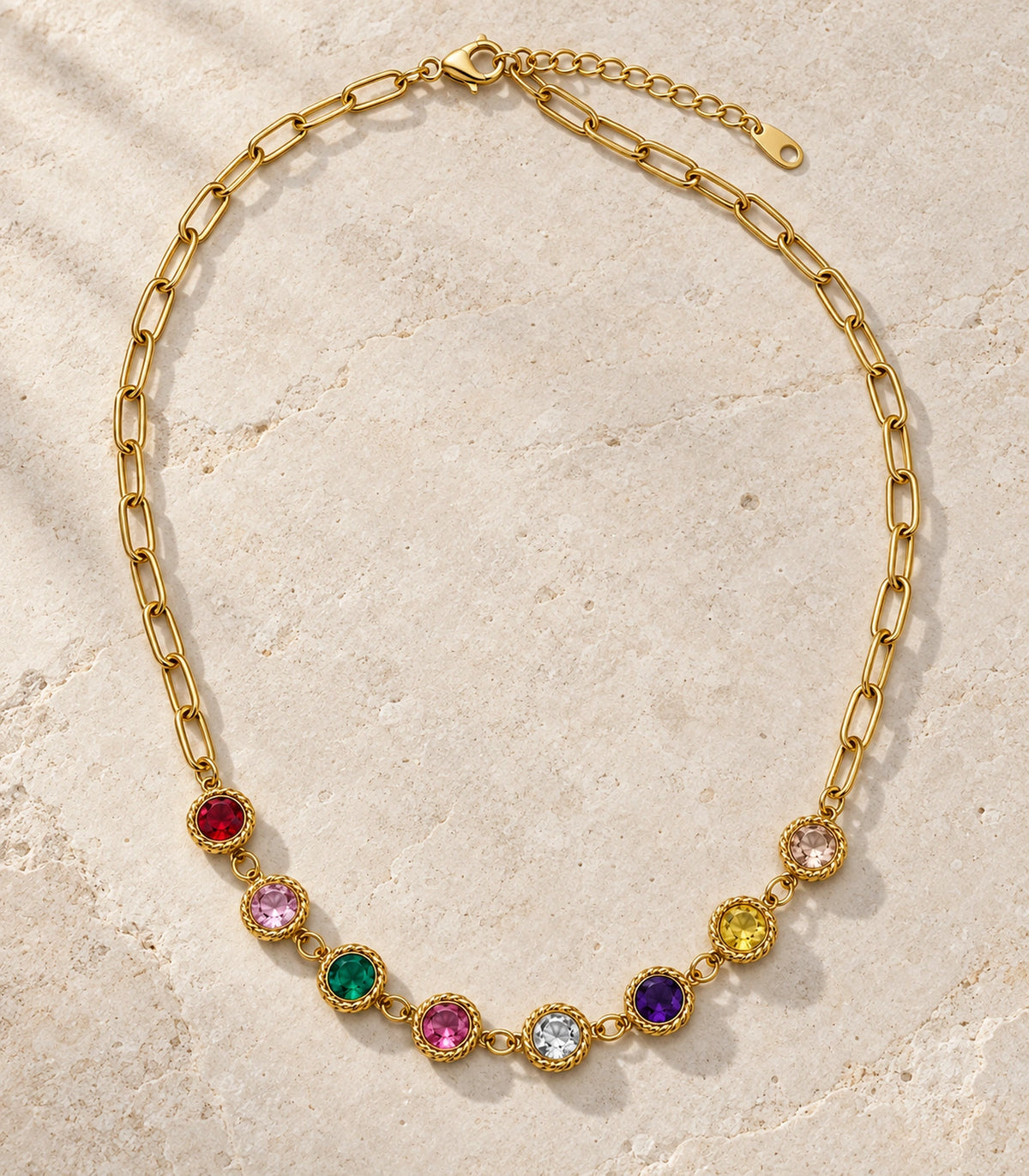 JIMIKI Gold Tone Multicolour Round Crystal Paperclip Necklace in Gold Tone / Multicolour - editorial flatlay #color_gold-tone-multicolour