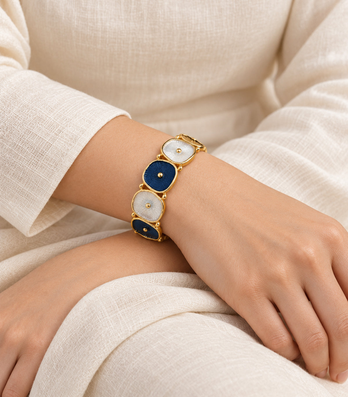 JIMIKI gold-tone navy and white oval disc bracelet — editorial model