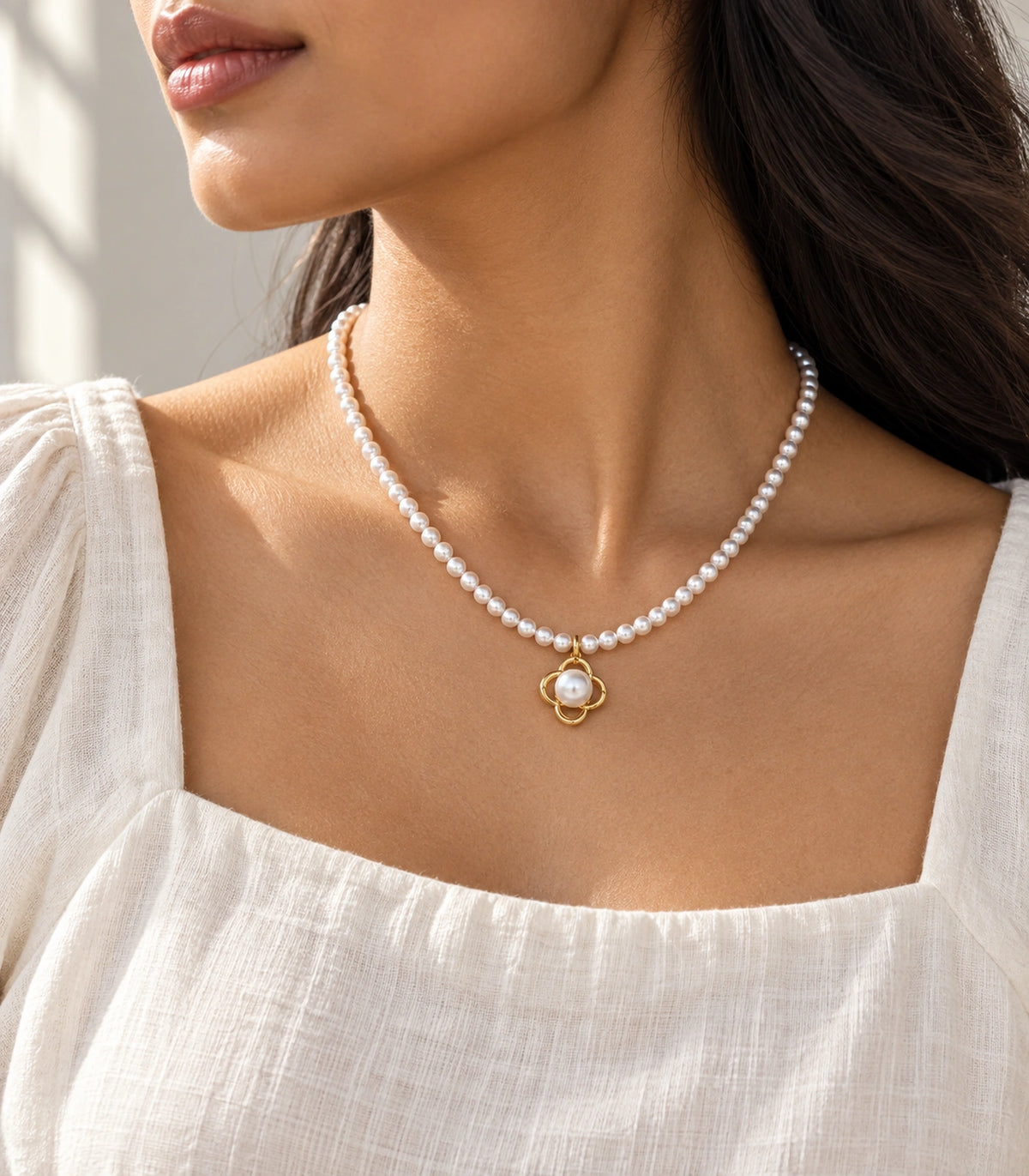 JIMIKI Gold Tone Open Clover Pearl Style Necklace in Gold tone / white, editorial model view