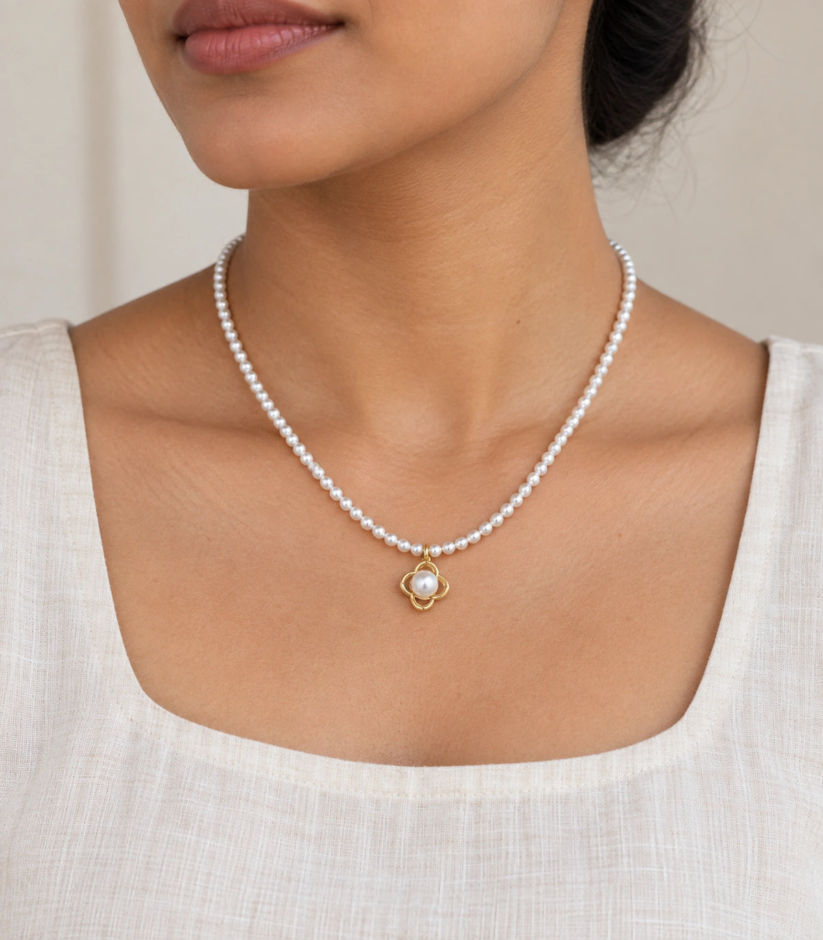 JIMIKI Gold Tone Open Clover Pearl Style Necklace in Gold tone / white, model wearing view