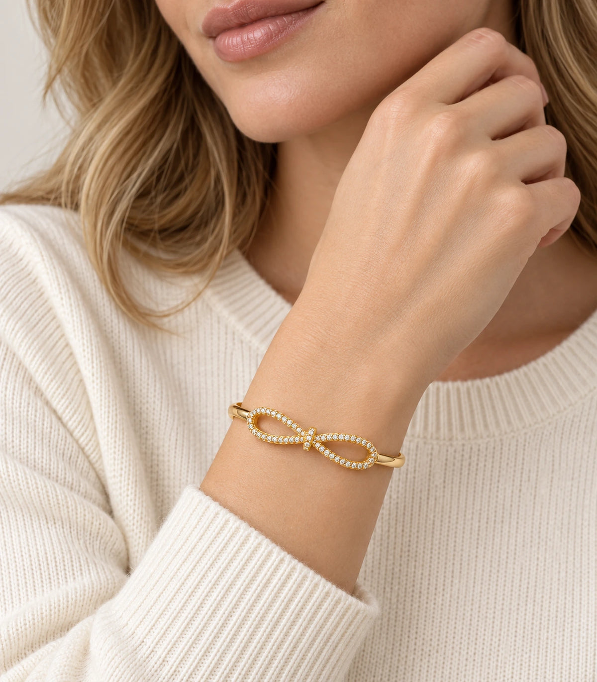 JIMIKI Gold-Tone Open Infinity Pavé Bangle — worn on the wrist #color_gold-tone / clear