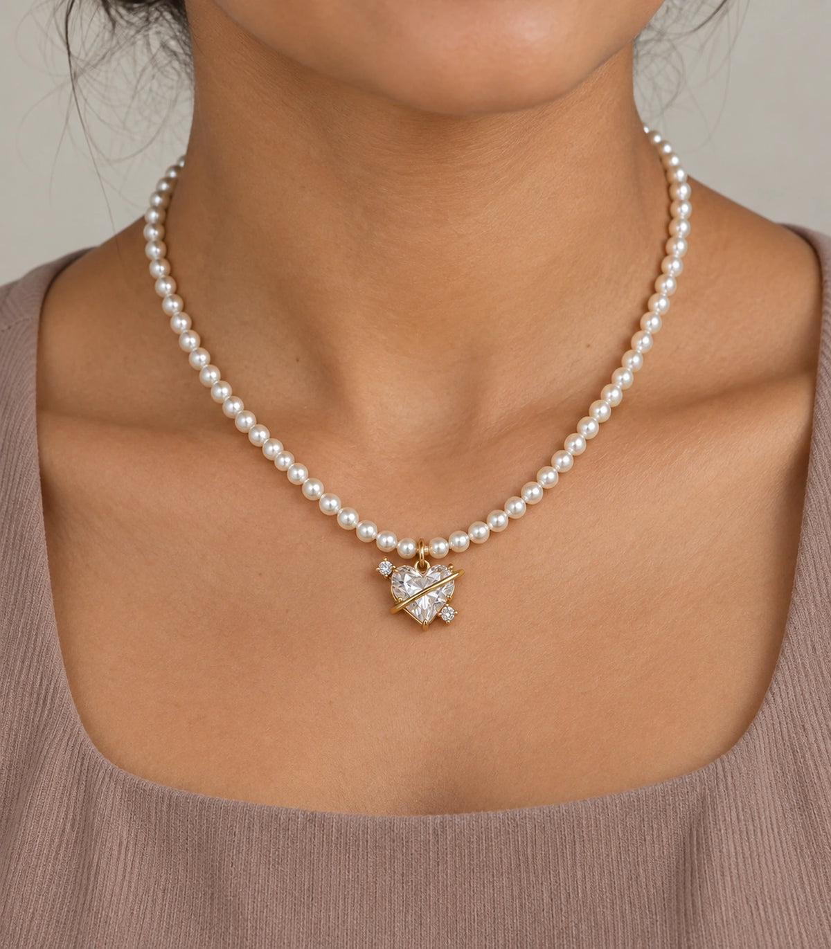 JIMIKI Gold Tone Orbit Heart Crystal Pearl Style Necklace in Gold tone / white, model wearing view