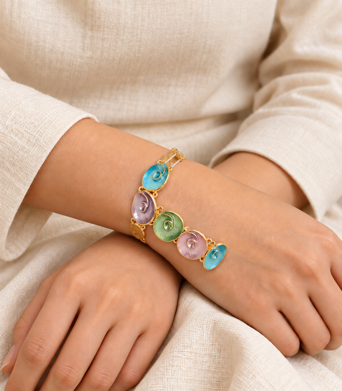 Gold-tone pastel spiral disc bracelet - editorial model view, one bracelet