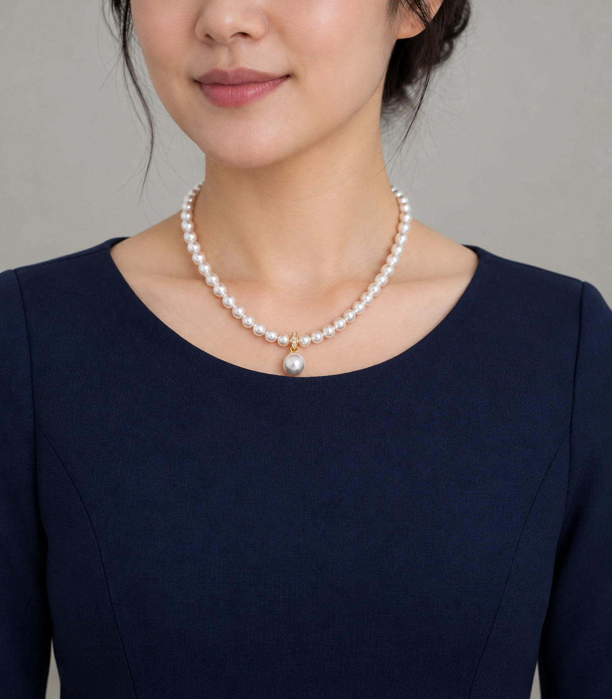 JIMIKI Gold-Tone Pavé Bail Pearl Drop Necklace in Gold-tone, worn with a simple outfit