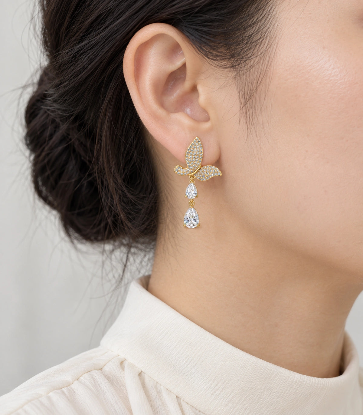 JIMIKI Pave Butterfly Double Teardrop Earring Pair in Gold-tone, model wearing view #color_gold-tone