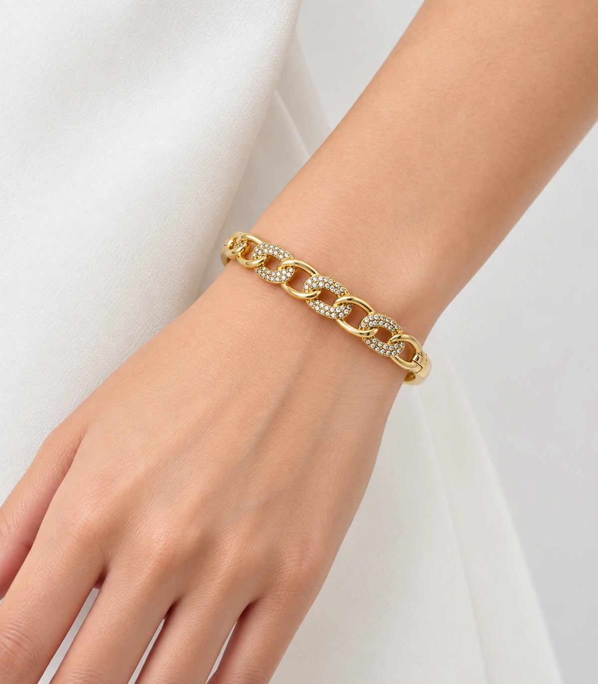 JIMIKI Gold-Tone Pavé Chain Link Bangle — worn on the wrist #color_gold-tone / clear
