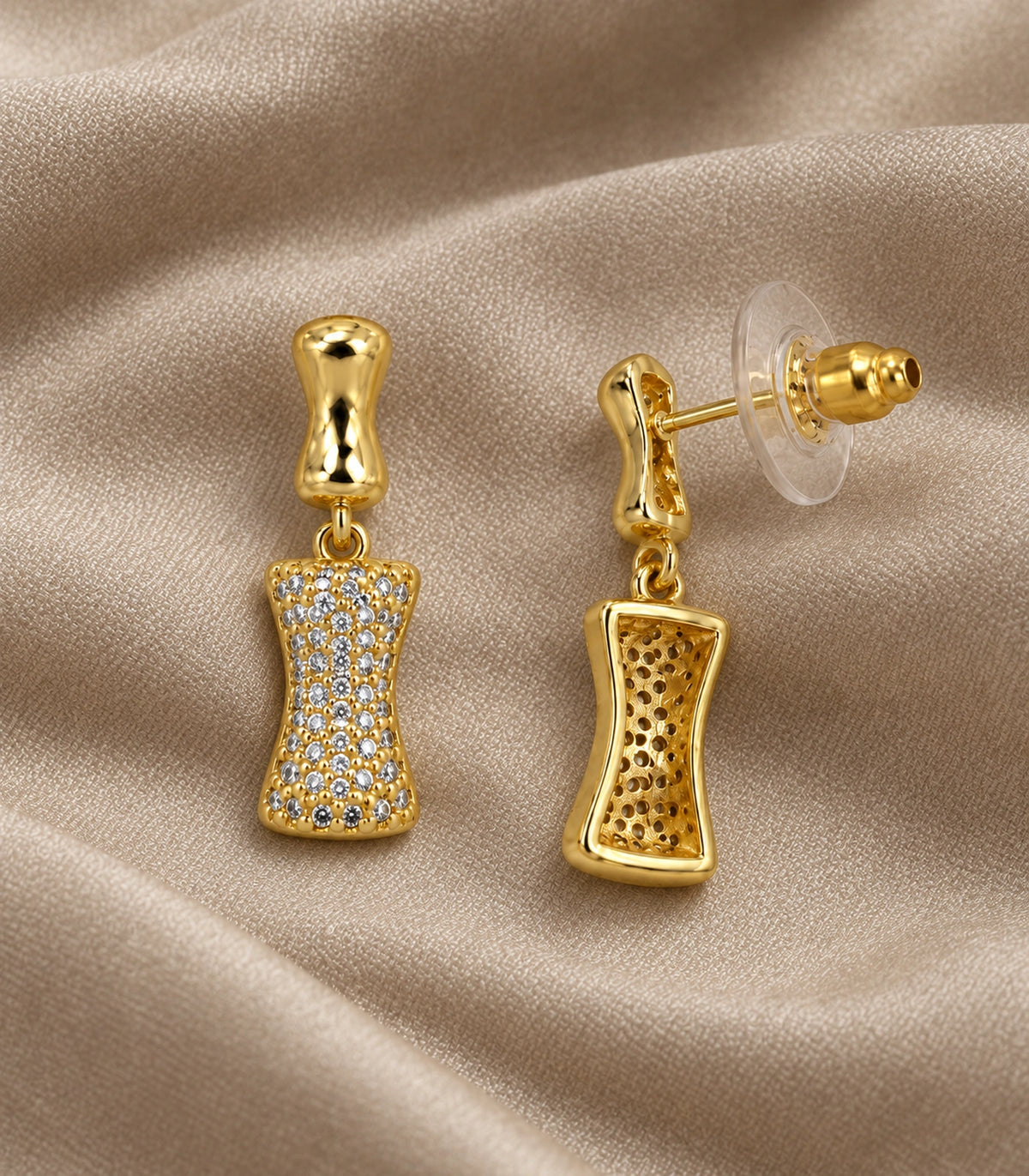 JIMIKI Pave Hourglass Drop Earring Pair in Gold tone, editorial flat lay #color_gold tone