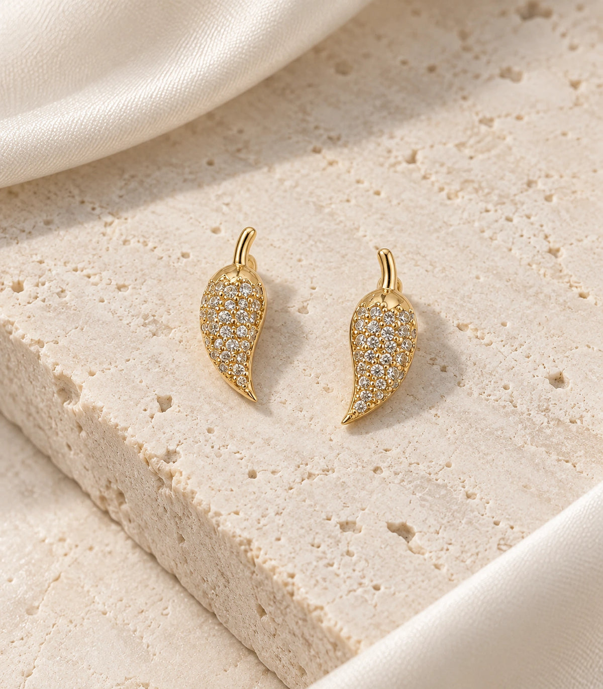 JIMIKI Gold Tone Pave Leaf Stud Earrings - editorial-flatlay #color_gold-tone