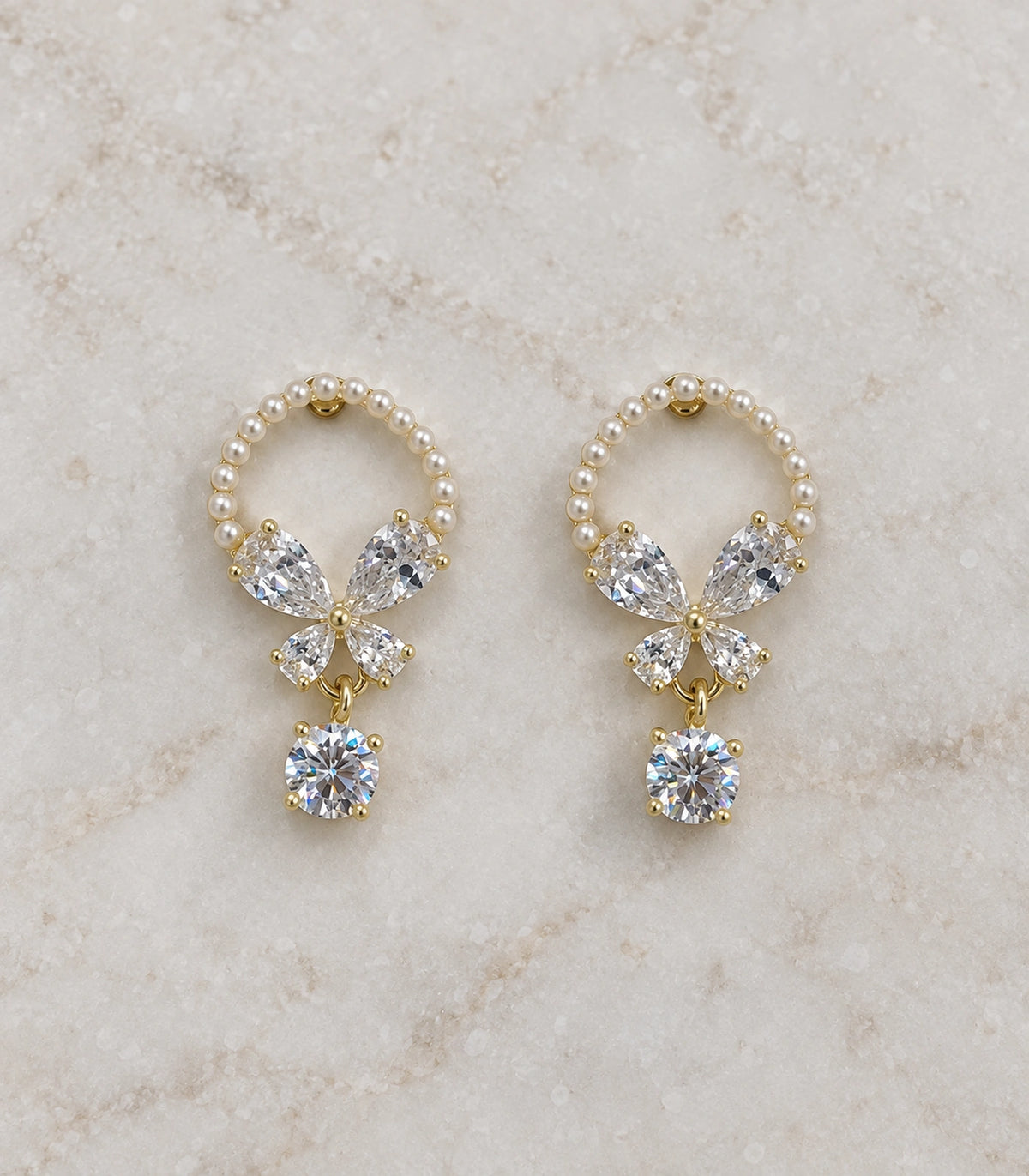 JIMIKI Gold Tone Pearl Loop Crystal Butterfly Drop Earring Pair in Gold-tone, editorial flat lay