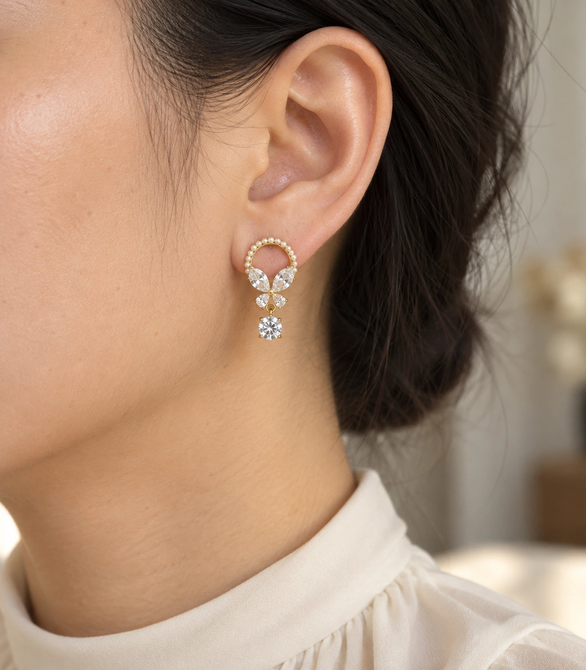 JIMIKI Gold Tone Pearl Loop Crystal Butterfly Drop Earring Pair in Gold-tone, editorial model view