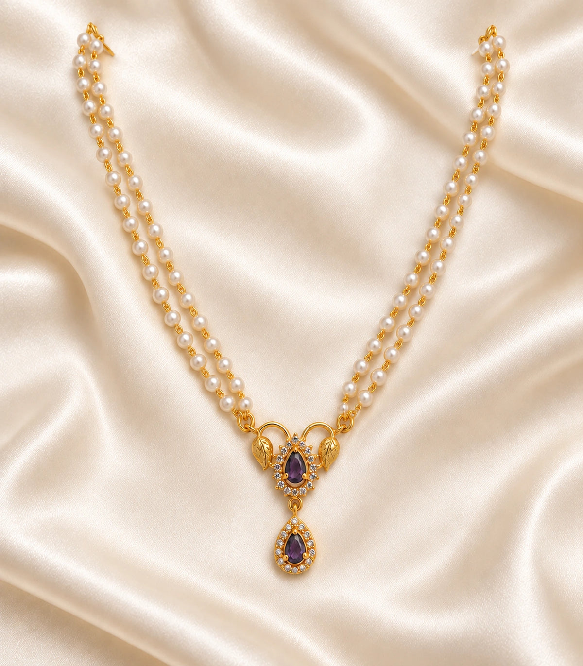 One purple leaf pendant necklace with twin white bead strands arranged completely on ivory satin; no earrings.