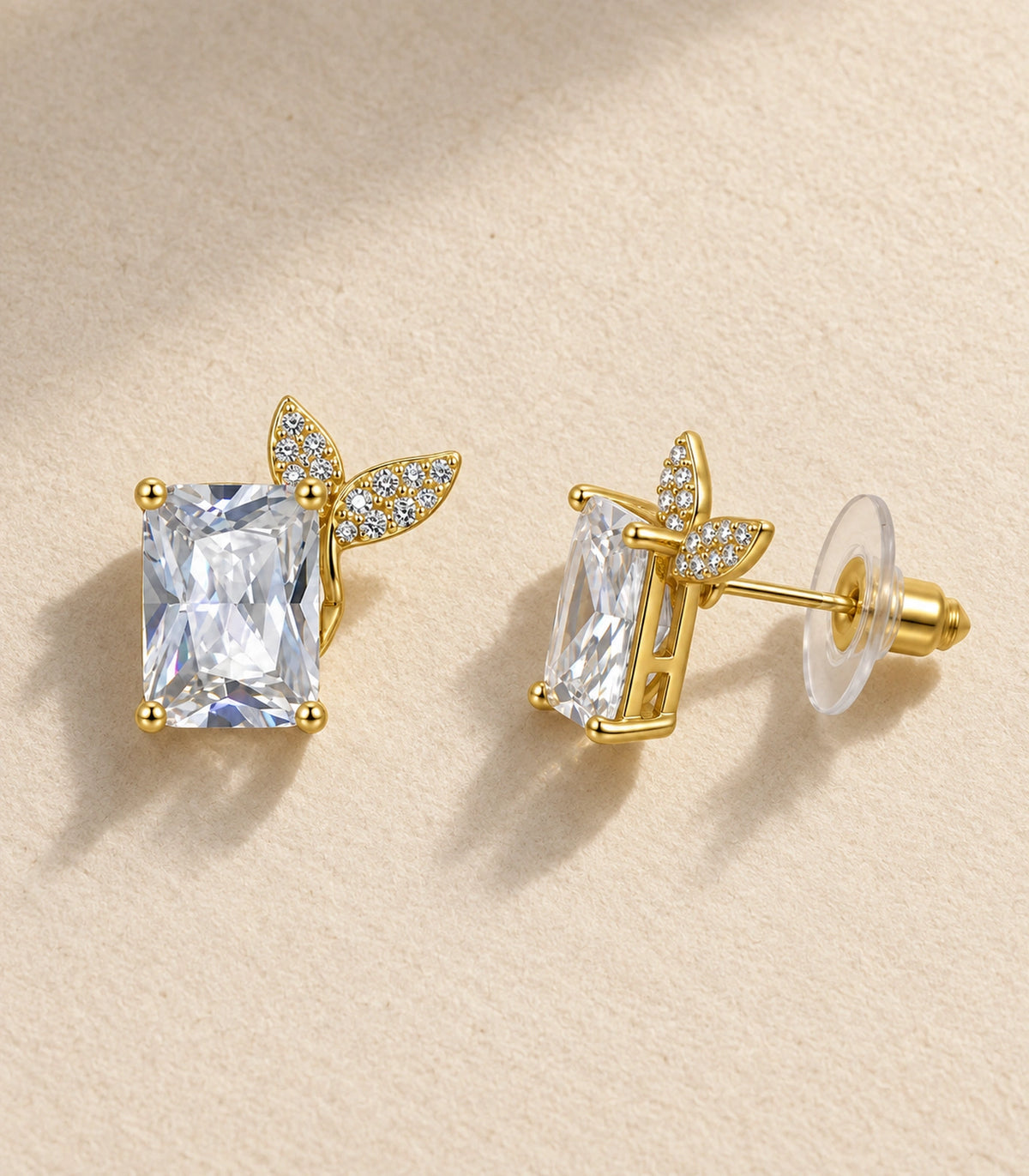 JIMIKI Rectangular Crystal Twin Leaf Stud Earring Pair in Gold-tone, editorial flat lay #color_gold-tone