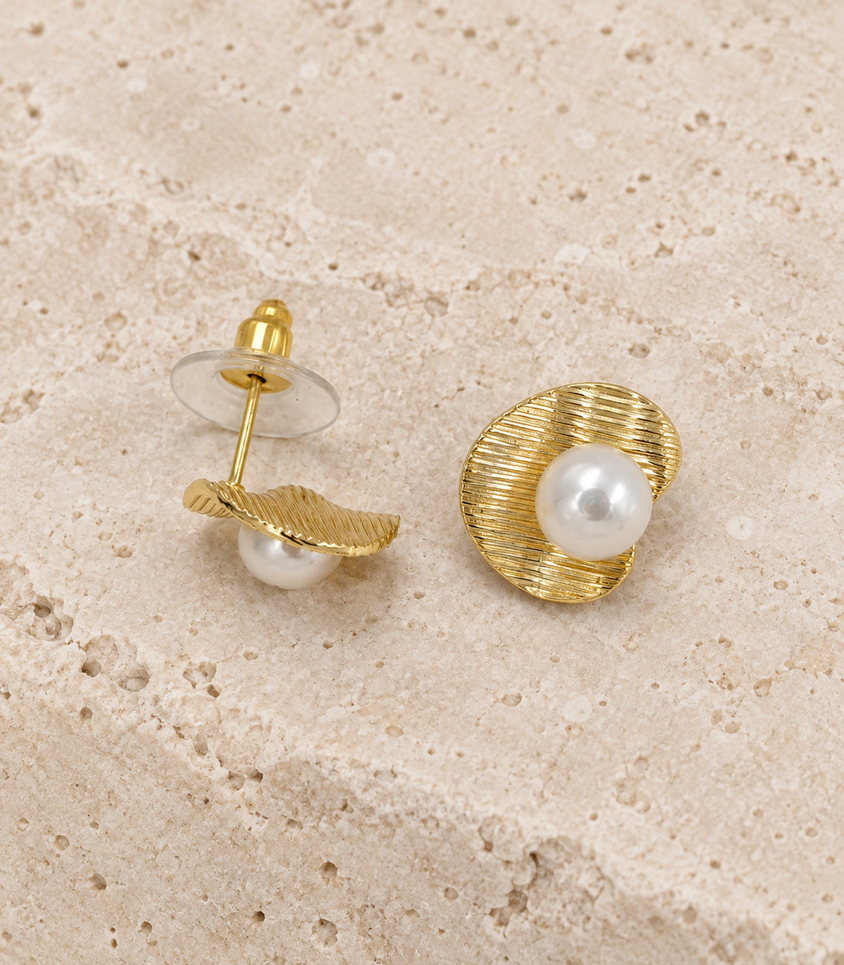 JIMIKI Ribbed Curved Disc Pearl Stud Earring Pair in Gold tone / White, editorial flat lay #color_gold tone / white