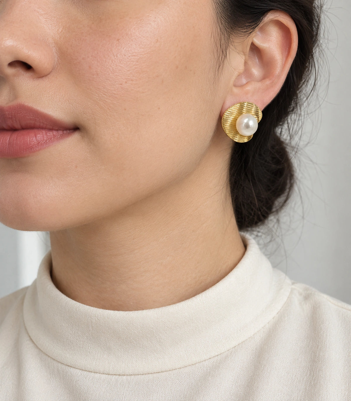 JIMIKI Ribbed Curved Disc Pearl Stud Earring Pair in Gold tone / White, model wearing view #color_gold tone / white