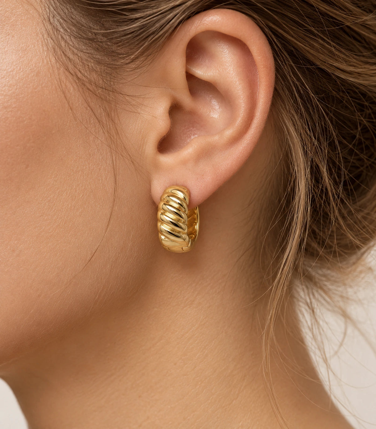 JIMIKI Gold Tone Ribbed Hoop Earrings in Gold Tone - editorial model #color_gold-tone
