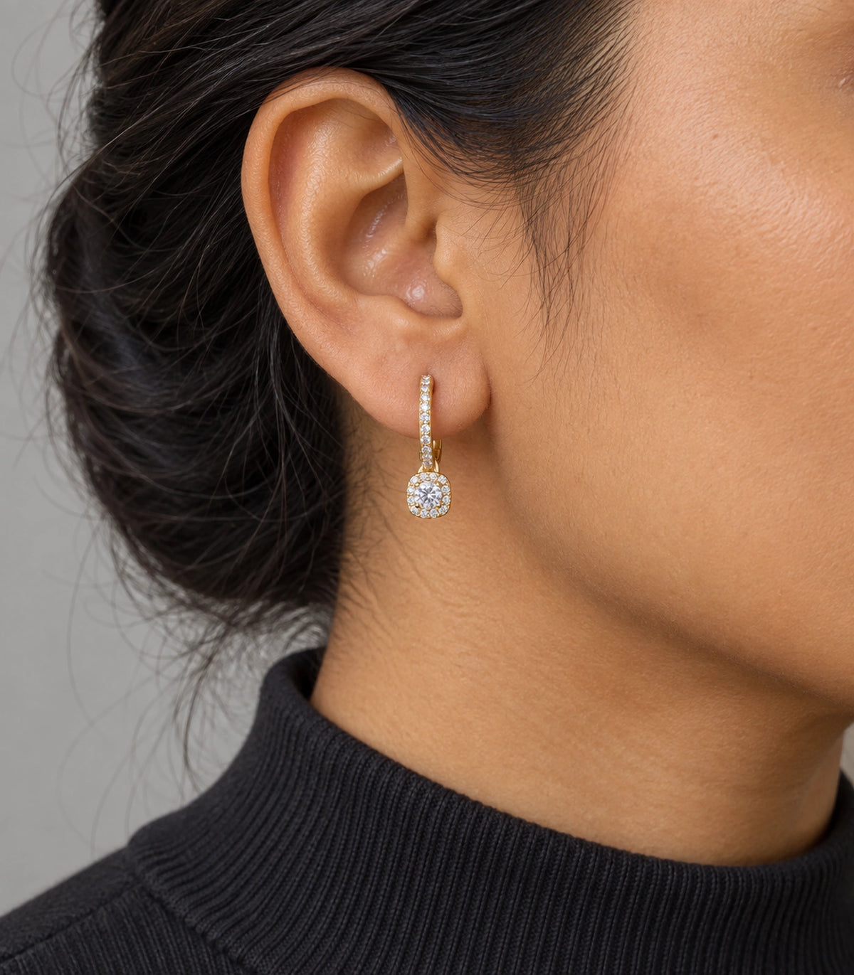 JIMIKI Gold-Tone Round Halo Solitaire Drop Huggie Earrings in Gold / Clear, model wearing view