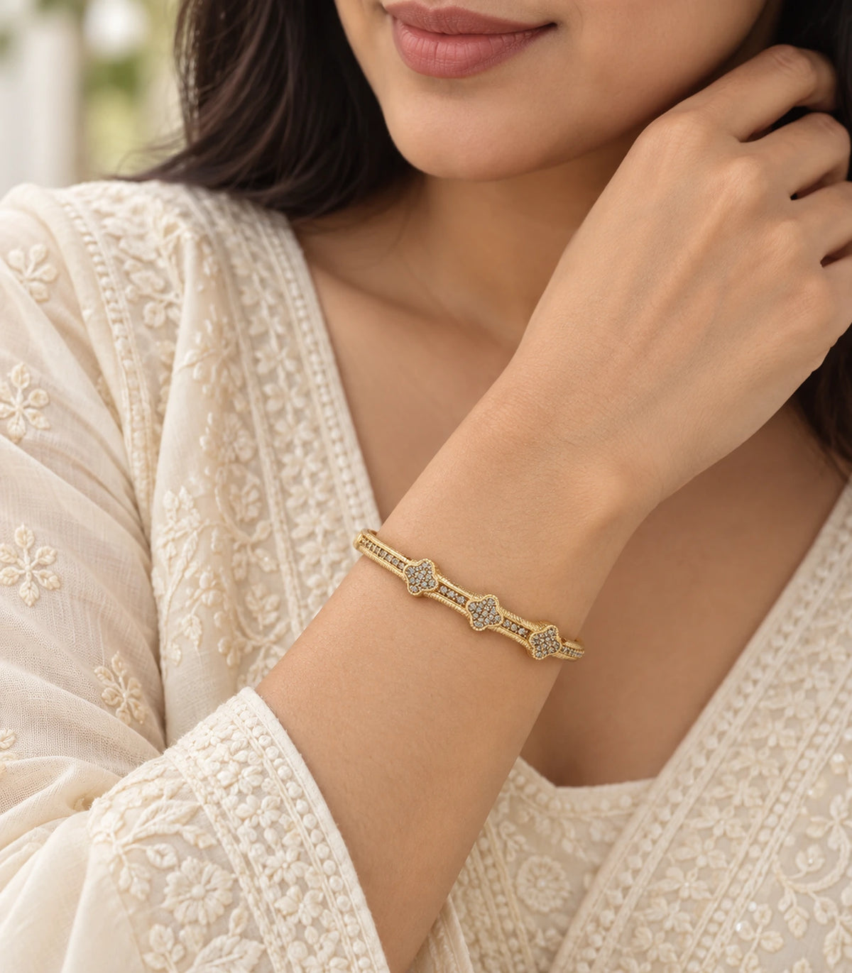 JIMIKI Gold-Tone Three Clover Pavé Bangle — worn on the wrist #color_gold-tone / clear