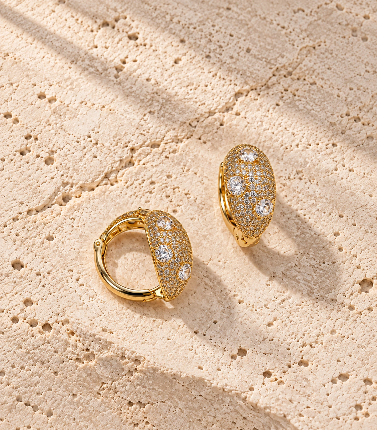 JIMIKI Three Crystal Domed Pave Hoop Earring Pair in Gold Tone, editorial flat lay #color_gold tone