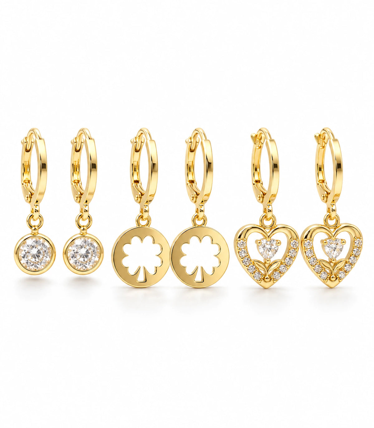 Complete gold-tone three-pair crystal, clover cutout and heart hoop earring set on white background