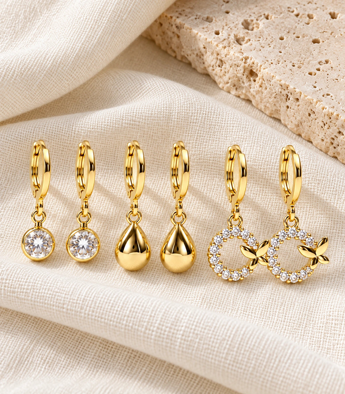 Full three-pair gold tone hoop earring set arranged as a flatlay